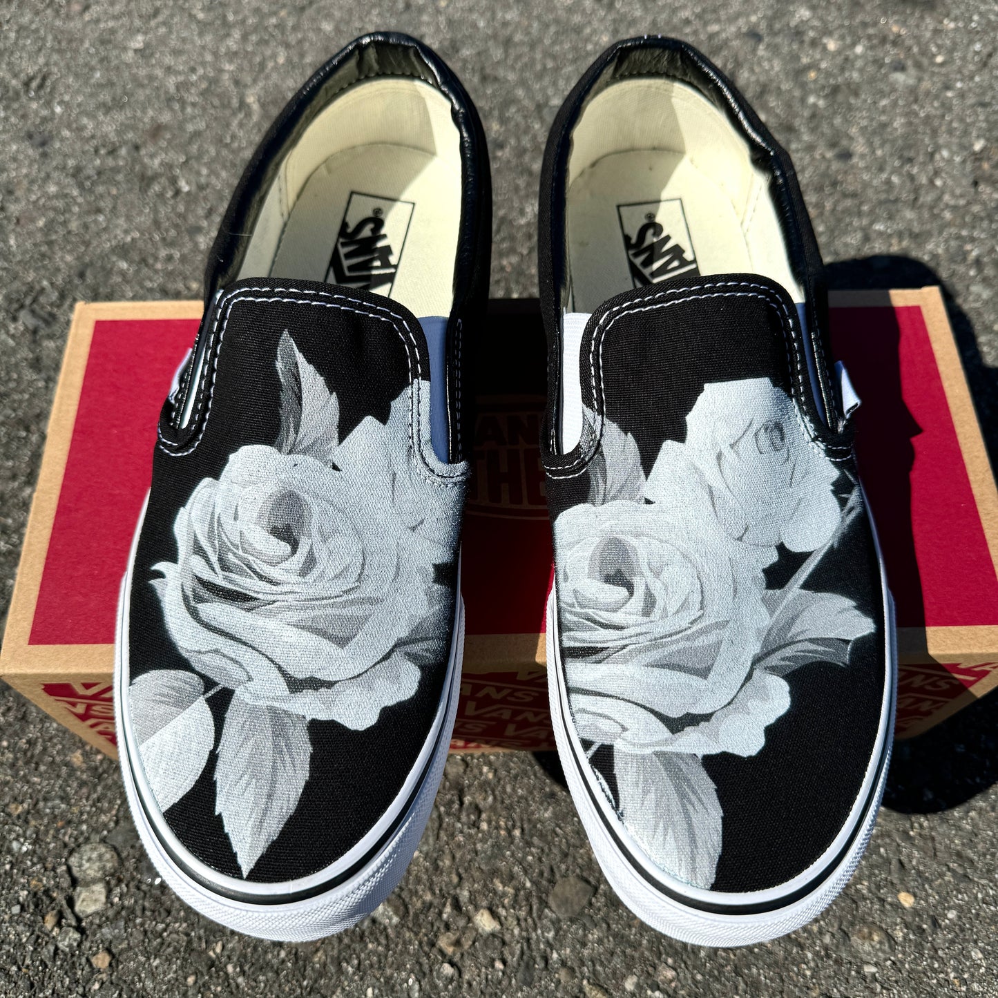 black slip on Vans with roses