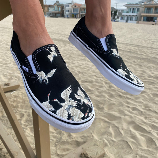 Take-Off Wearing These White Cranes on Black Slip-on Vans