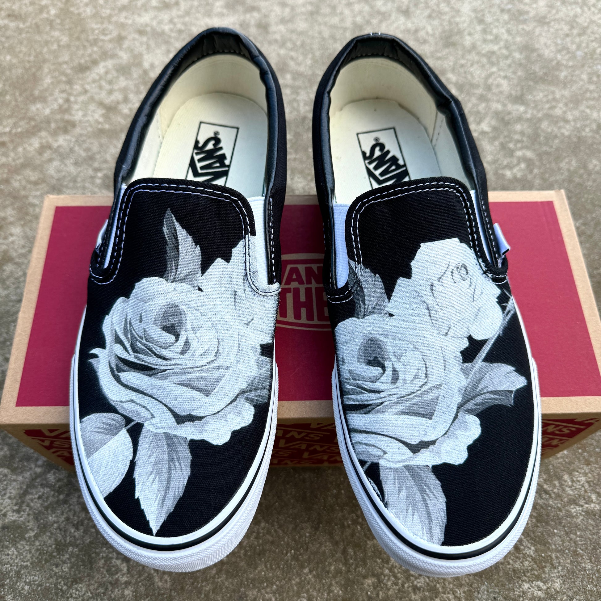 black slip on Vans with roses