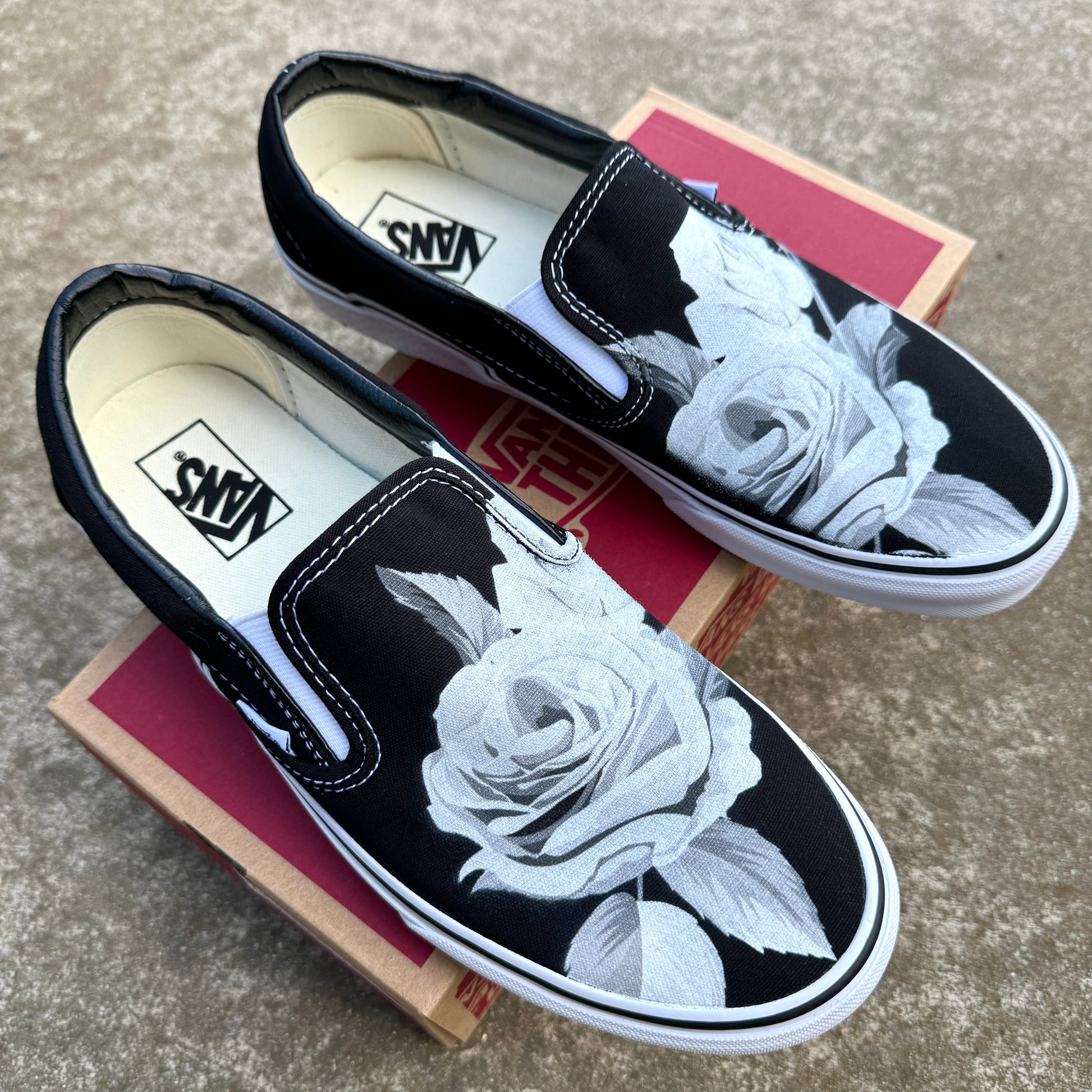 black slip on Vans with roses