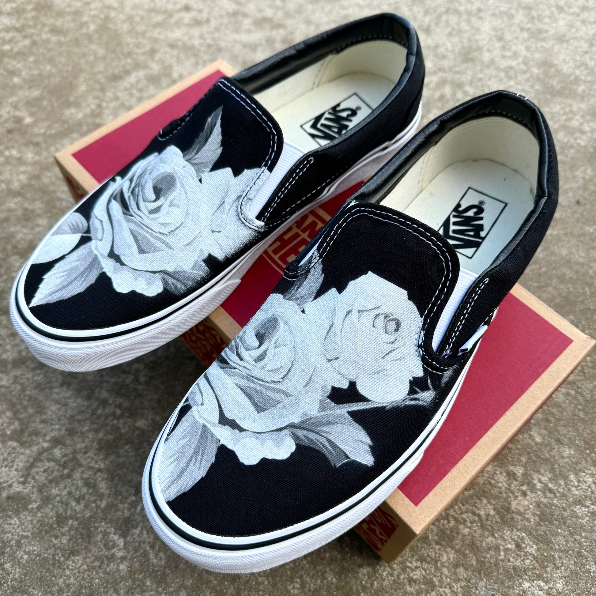 black slip on Vans with roses