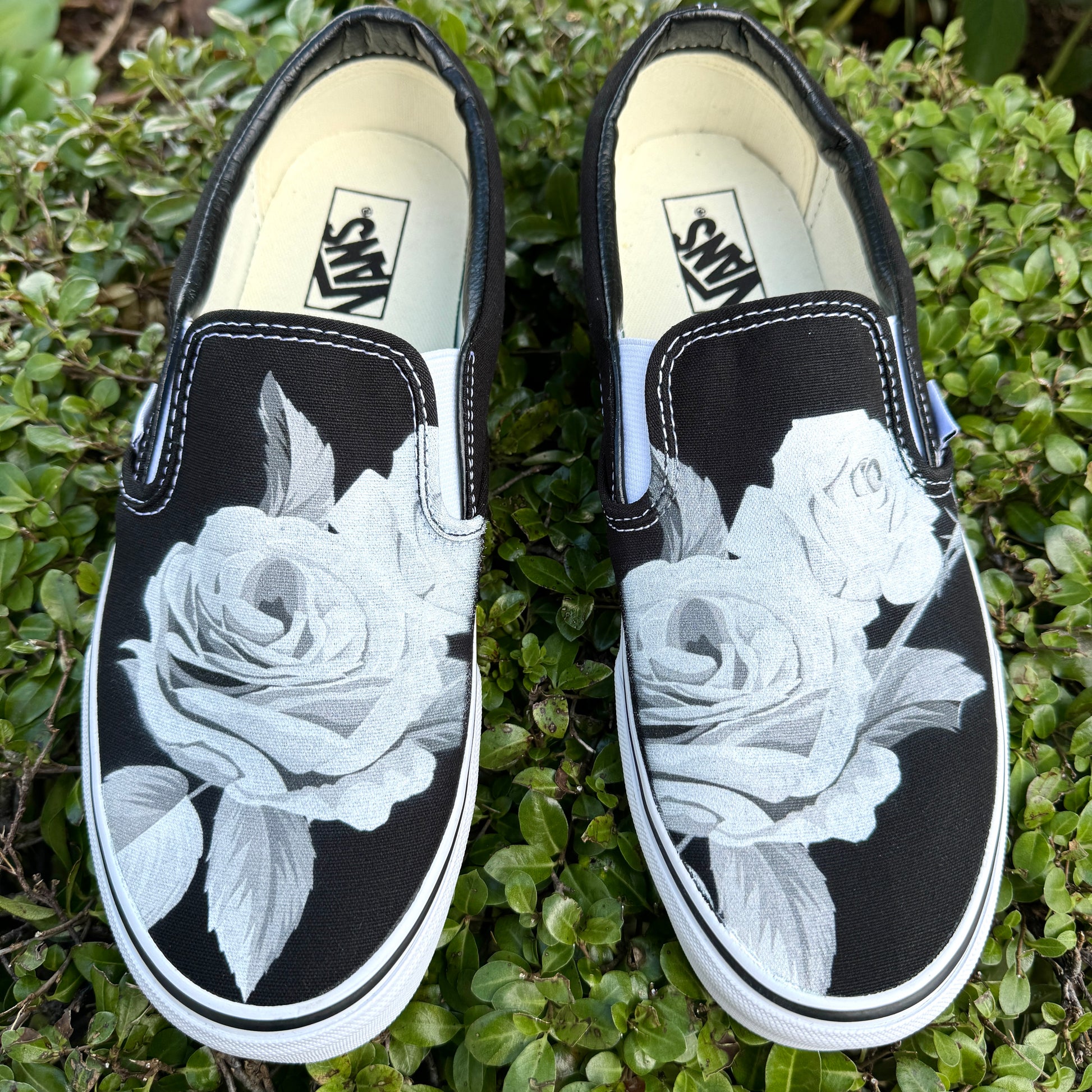 black slip on Vans with roses
